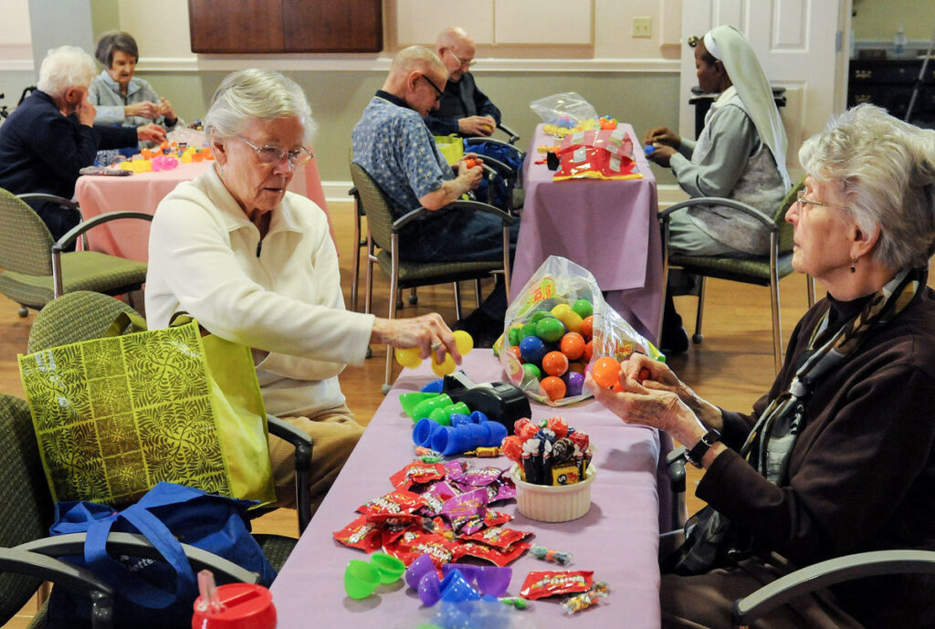 Residents putting candy and toys in eggs for Easter event