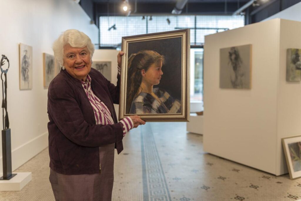 Senior woman holding a photo from Craig Hudson gallery