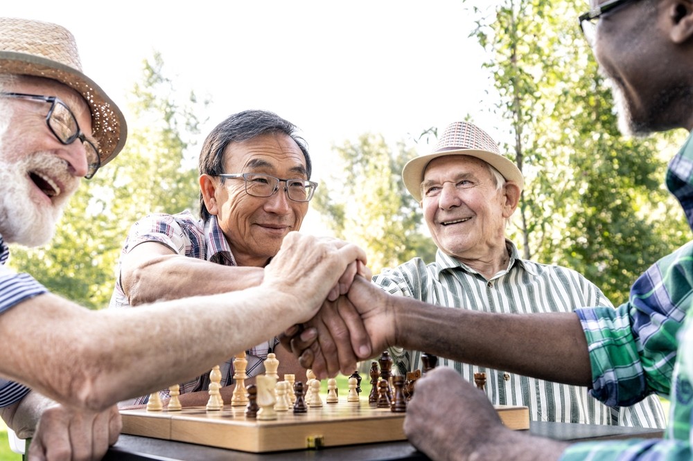 Senior friends playing chess together