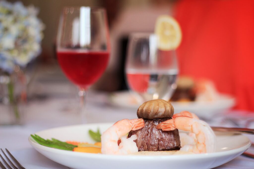 Plate of shrimp, steak, and drinks