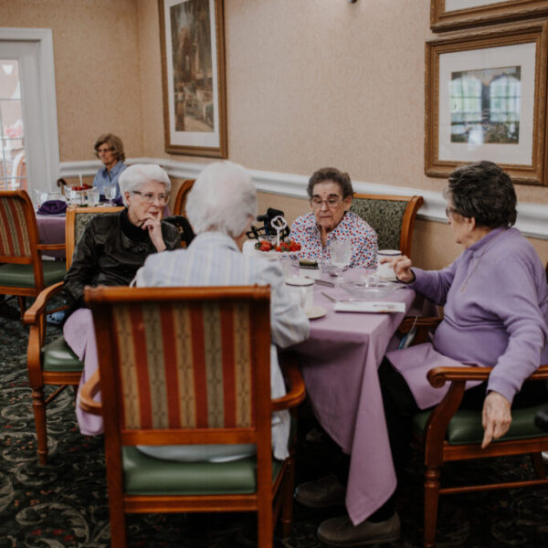 Residents eating at the table for the fashion show