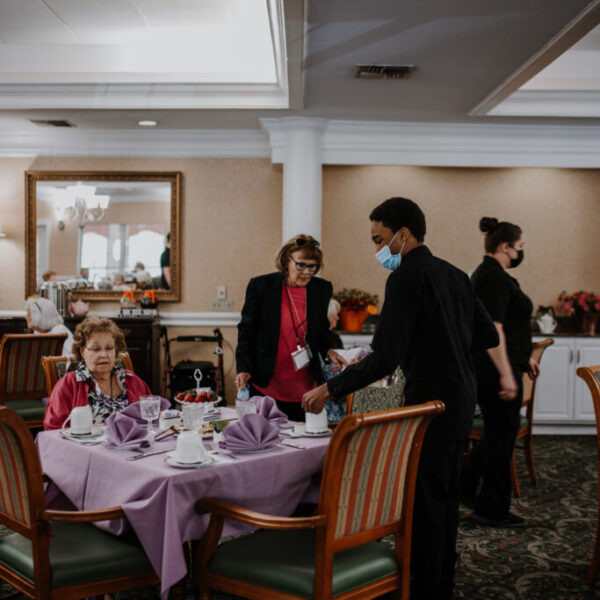 Staff member serving to the residents at the table