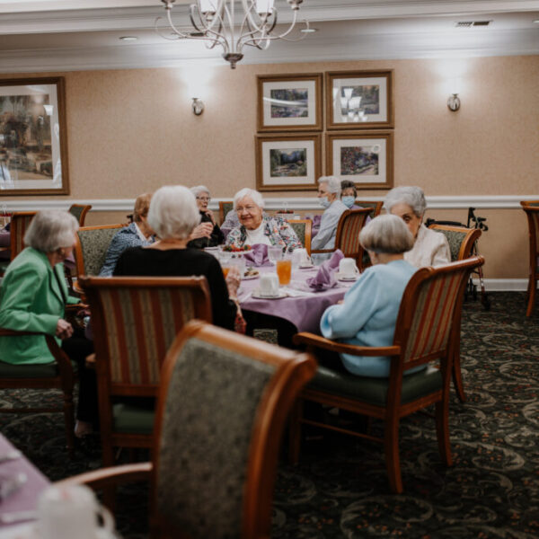 Residents talking to each other at the table at the fashion show