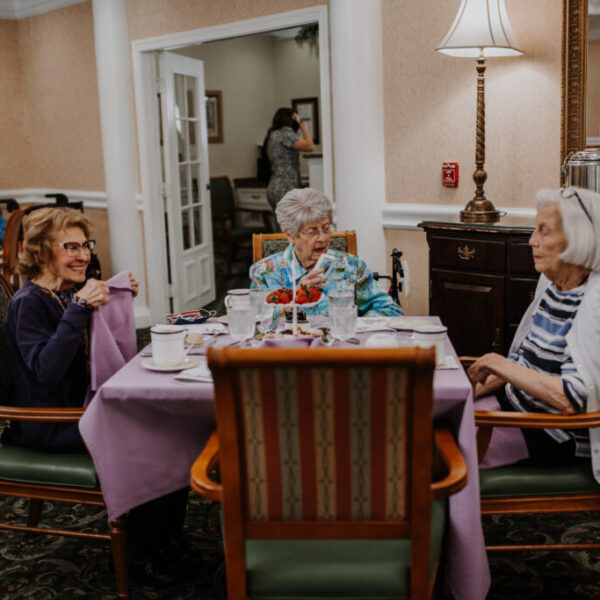 Residents gathered together at a table enjoying the refreshments