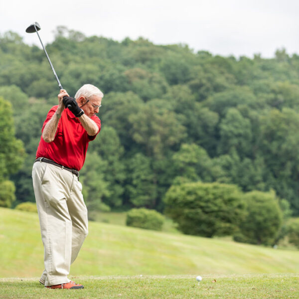 A senior man playing golf