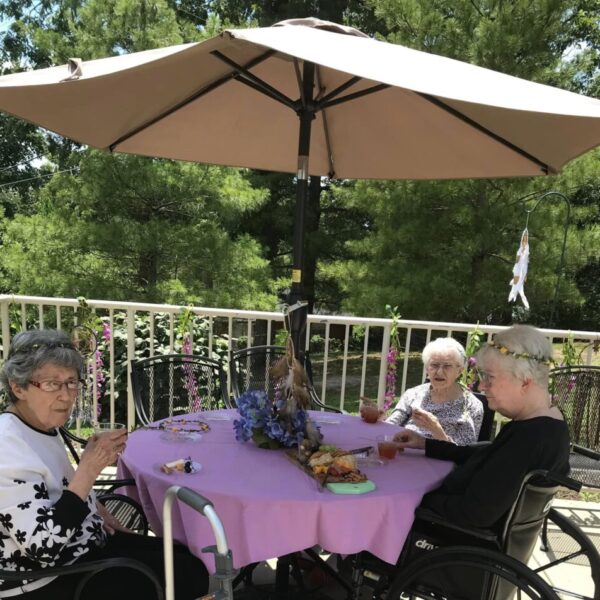 Seniors gathered at a table for the bohemian garden party