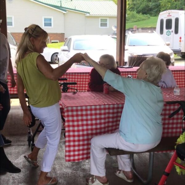 Residents and staff members dancing together