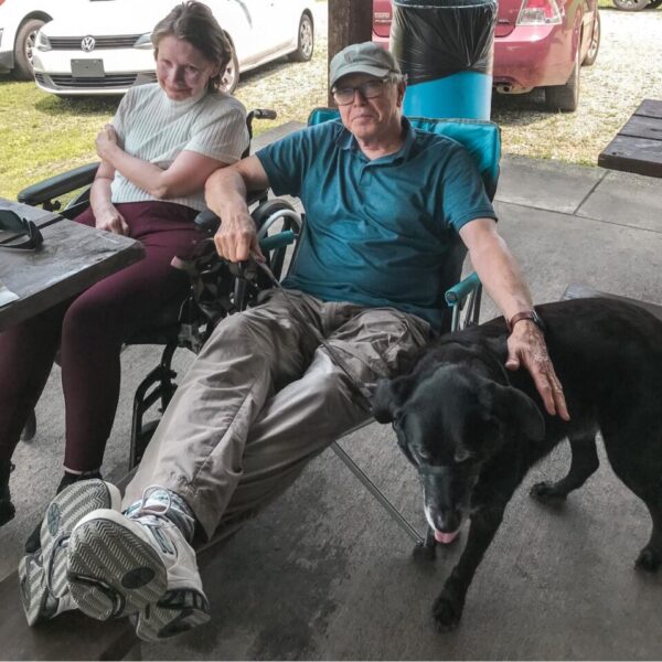 Residents with their dog, enjoying their time at the picnic