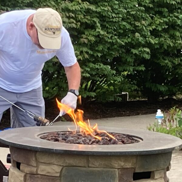 Staff member making smores at the firepit