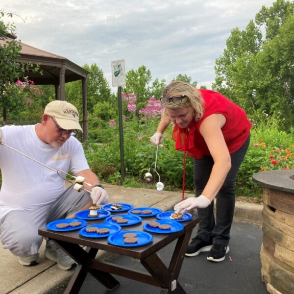 Staff members preparing smores for residents