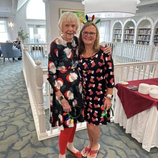 A resident and staff member posing at the Christmas in July Dance