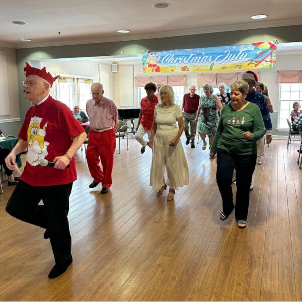 Residents on the dance floor completing a line dance together