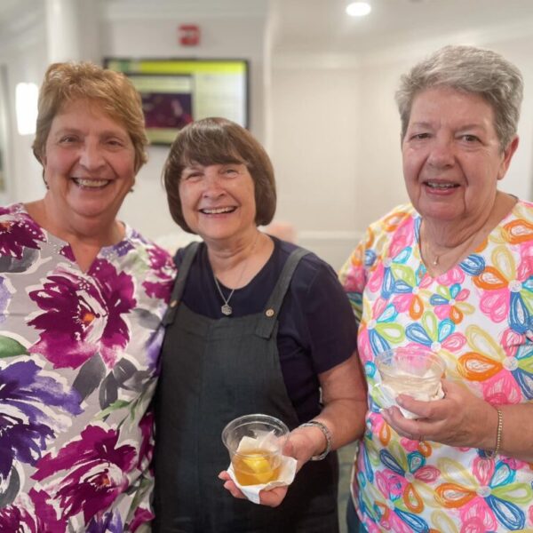 Three residents posing at 28th anniversary celebration