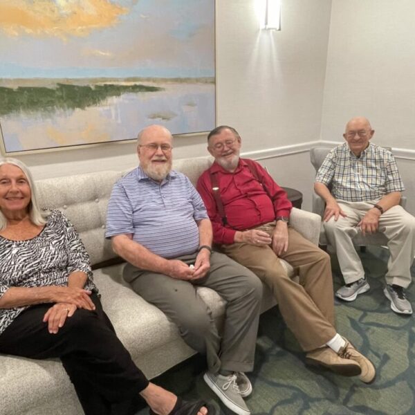 Residents sitting on a couch, ready to enter the party