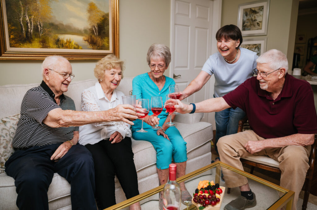 Residents toasting together in a living room