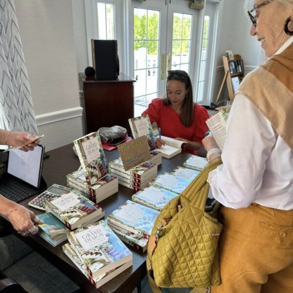 Author Joy Calleway signing a book for a resident