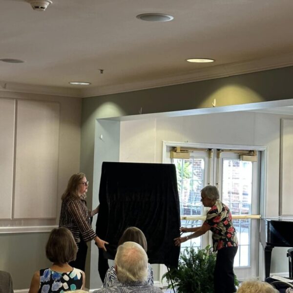 Staff preparing to unveil painting at the Newt and Nancy Thomas gallery