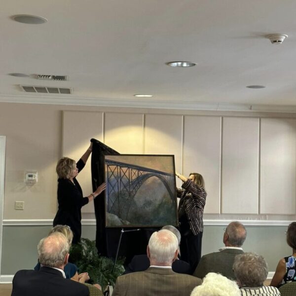 Staff unveiling the bridge painting at the Newt and Nancy Thomas gallery