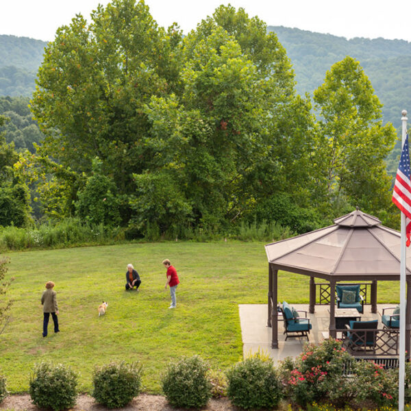 View of Kanawha State forest and resident playing their dog on the lawn