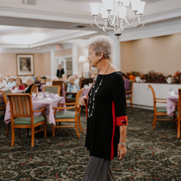 Resident walking around and admiring the work at the fashion show