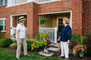 Two residents interacting with each other outside