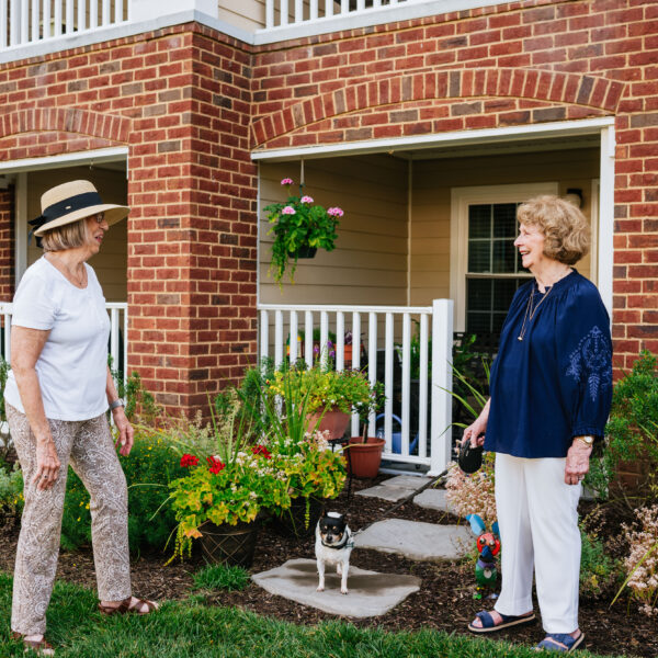 Two residents interacting with each other outside