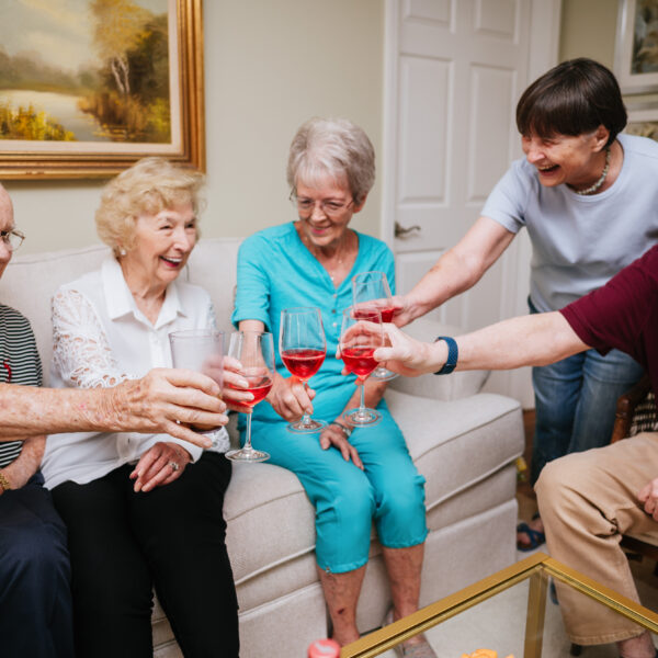 A group of five seniors toasting together