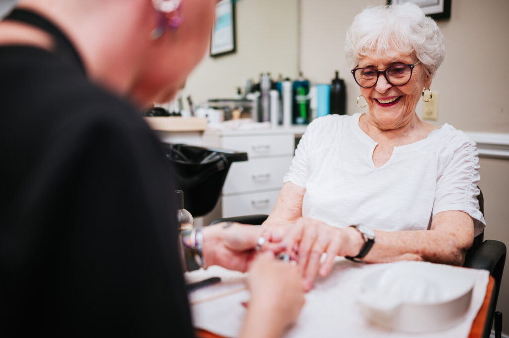 Woman getting her nails done at the community salon