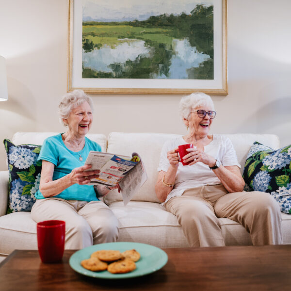 Two seniors enjoying each others company in the living room of the of apartments