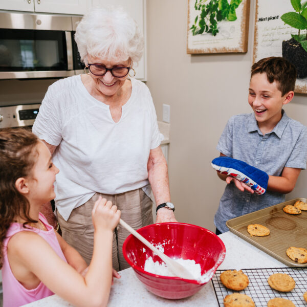 Resident baking cookies with her two grand-children in her residence