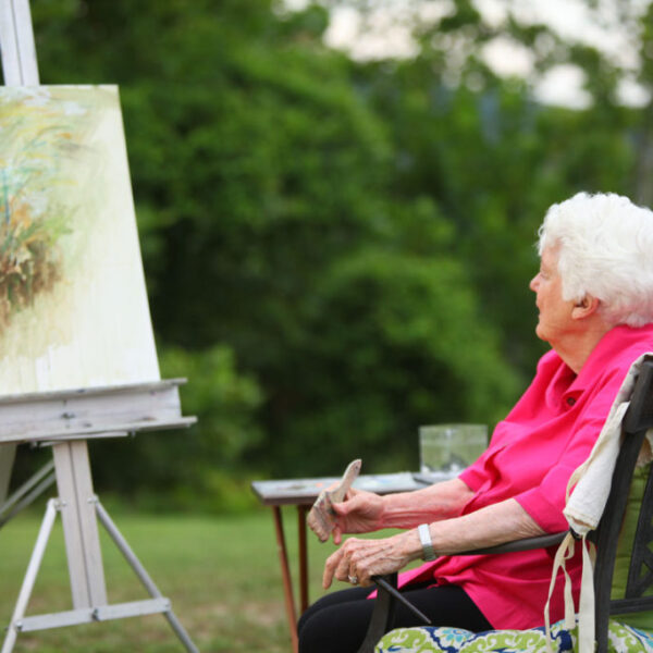 Resident painting on canvas outside