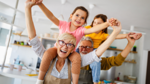 A senior couple playing with their two grand-daughters