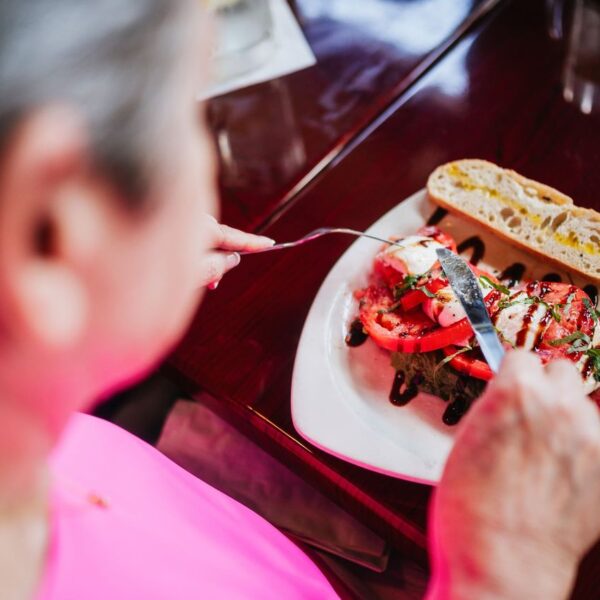 Woman eating her Caprese salad at a wine bar